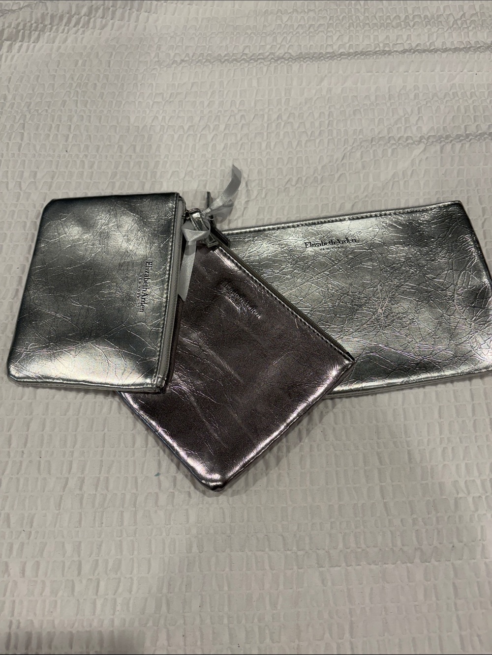 Elizabeth Arden Metallic Cosmetic Pouch Set in Silver and Rose silver
NWOT